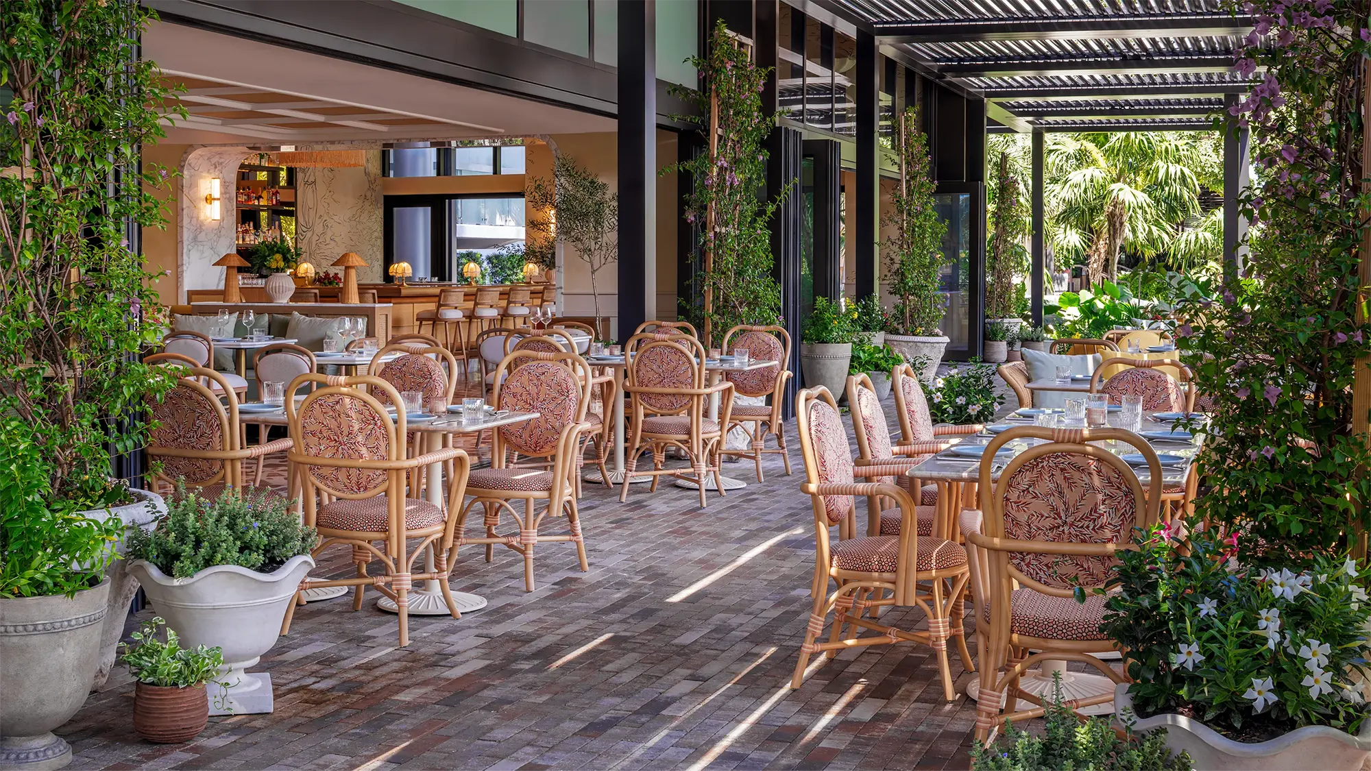 Indoor and outdoor seating at Elia on the River restaurant featuring wooden furniture and a cozy indoor space