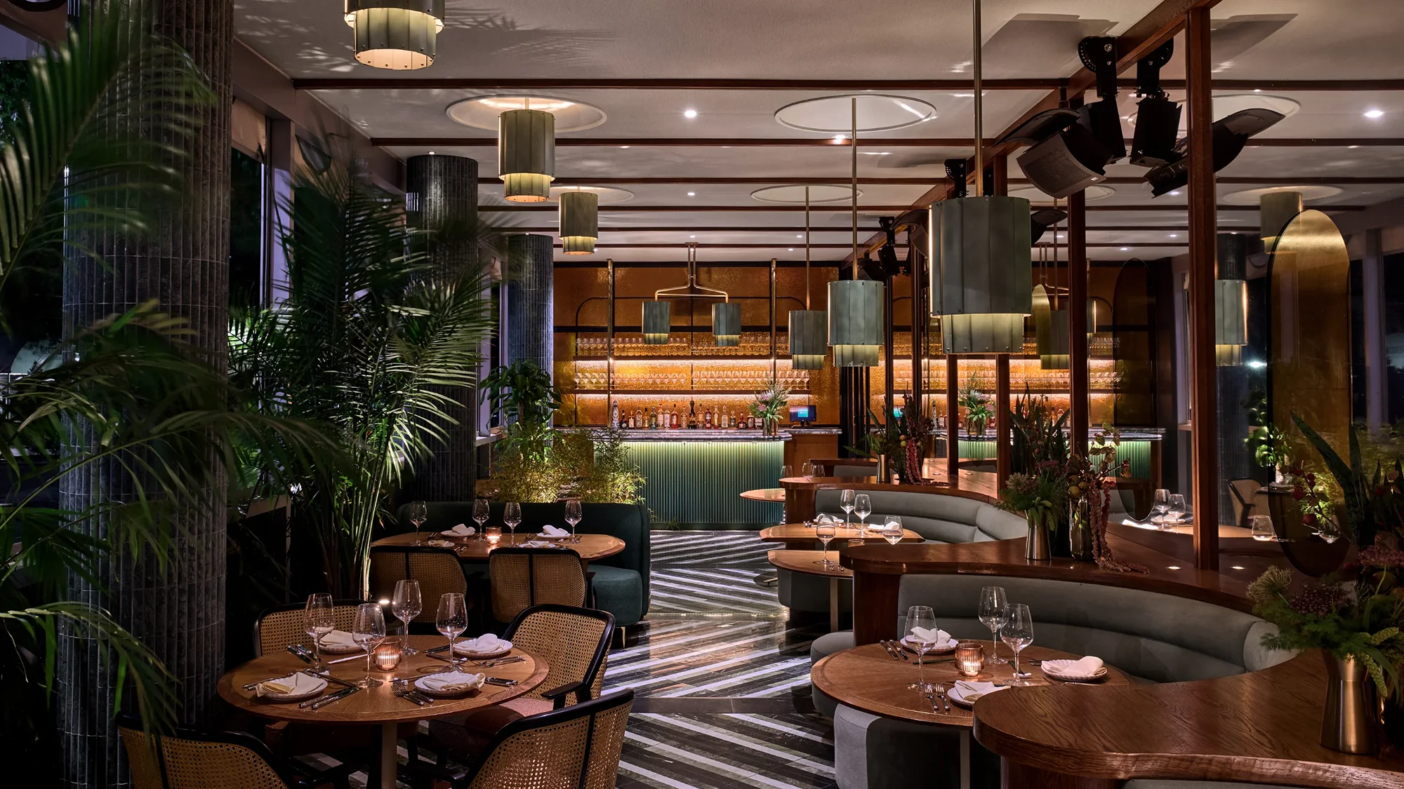 An elegantly designed restaurant dining room area with custom wooden furniture